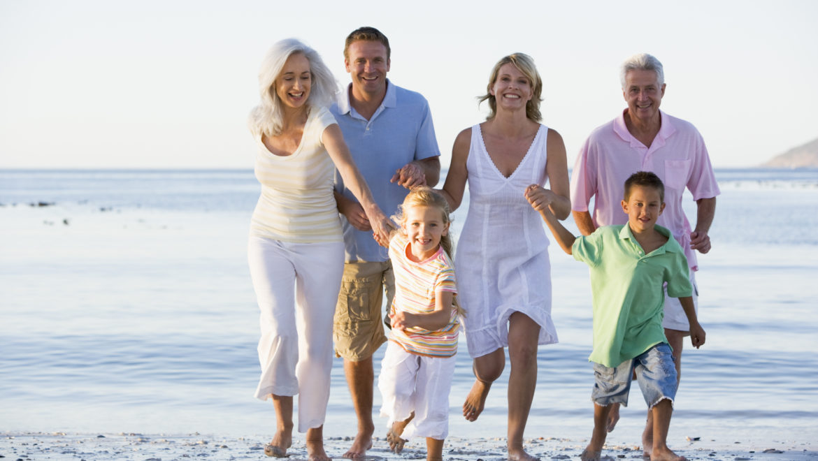 Healthy family walking on beach